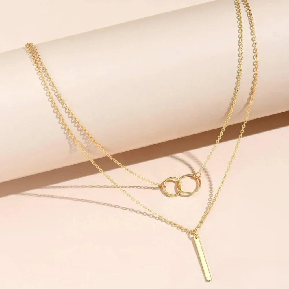 Nina | Collana rétro dorata con ciondolo a doppio cerchio
